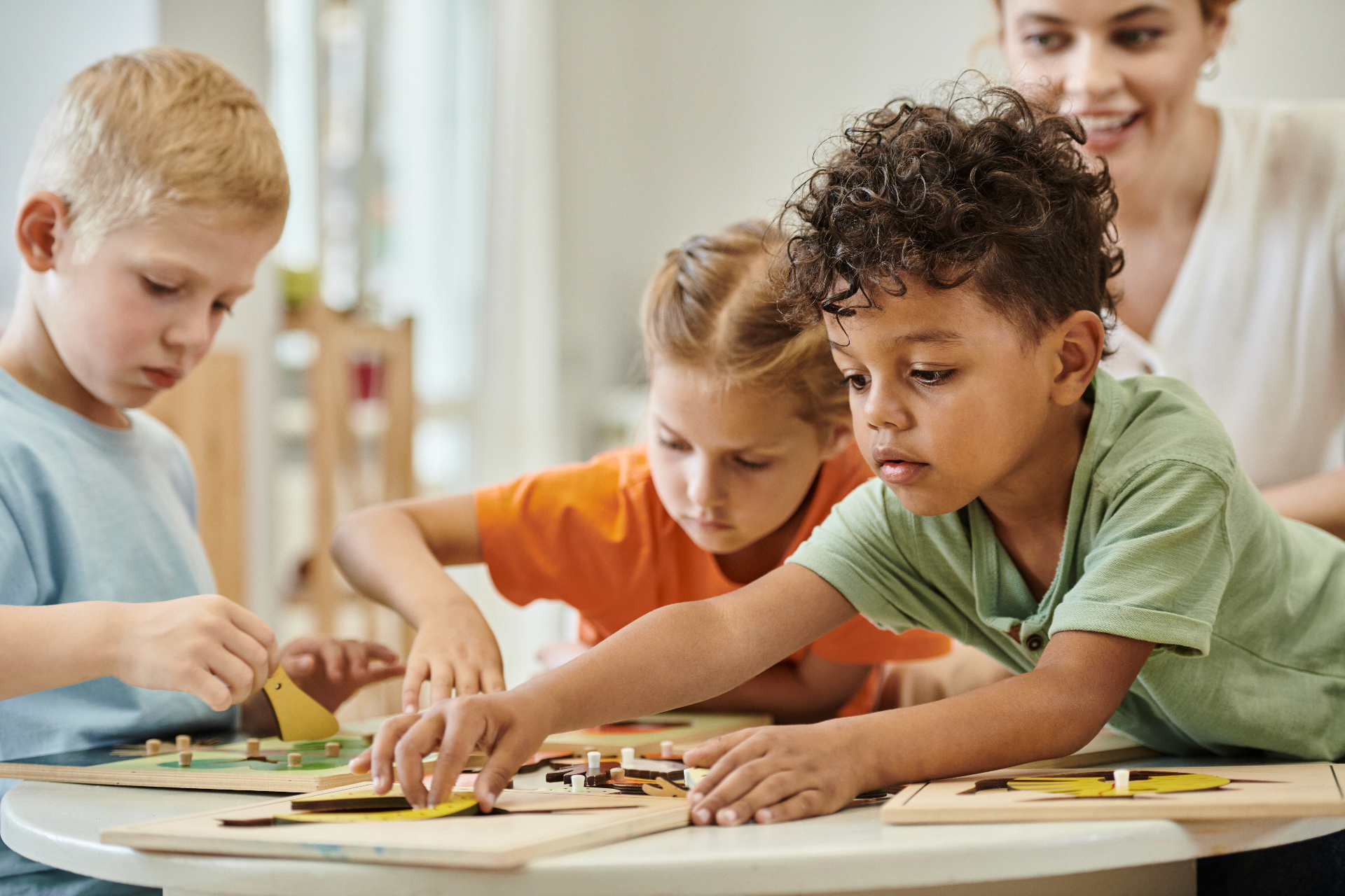 Children playing with wooden puzzles